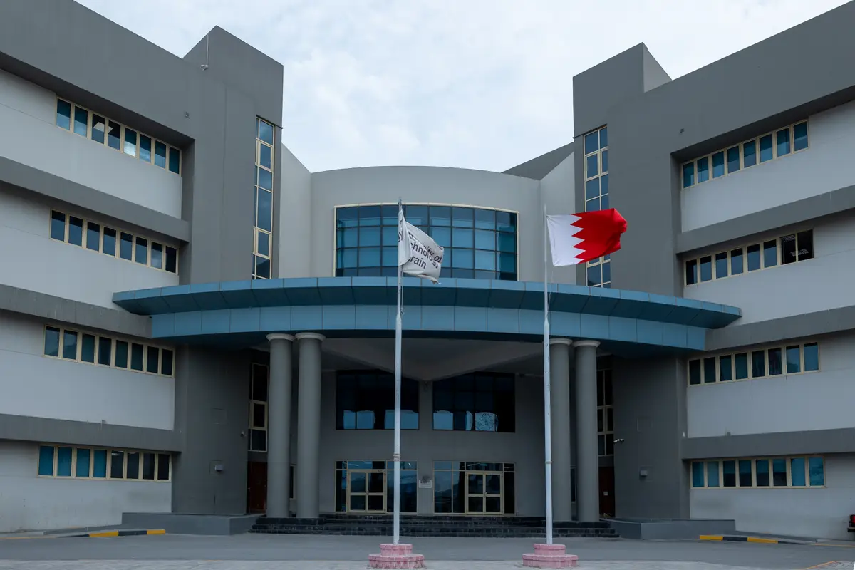 The University of Technology Bahrain campus building in Salmabad, with the Bahrain flag.