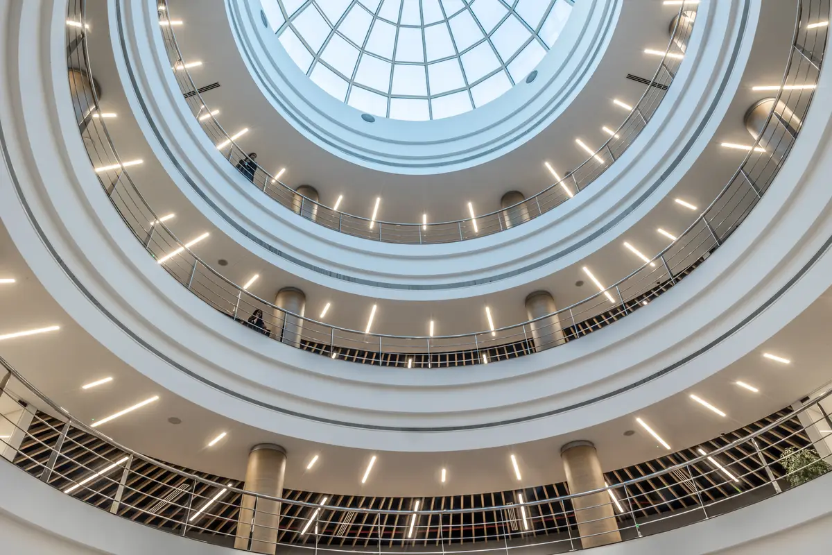 The daylit central atrium at UTB, seen from below its circular skylight.