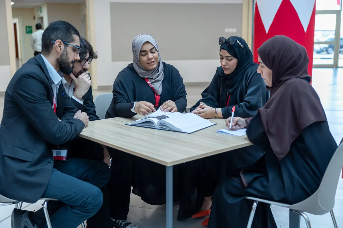 Students collaborating around a table at UTB.