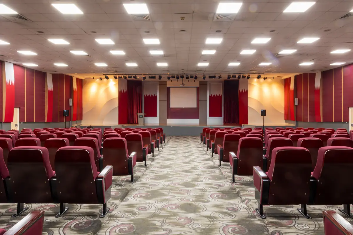 The tiered auditorium at UTB with red seating.