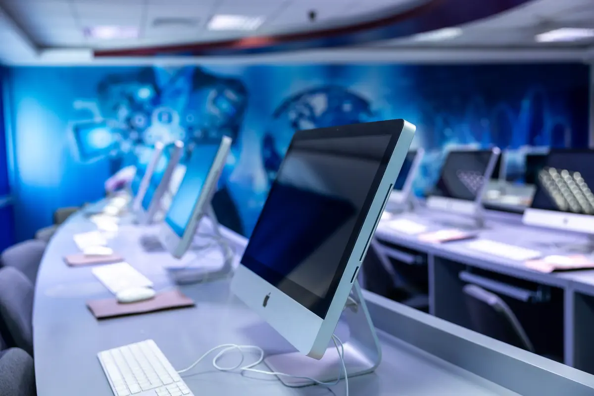 The iMac computing lab at UTB lit in blue.