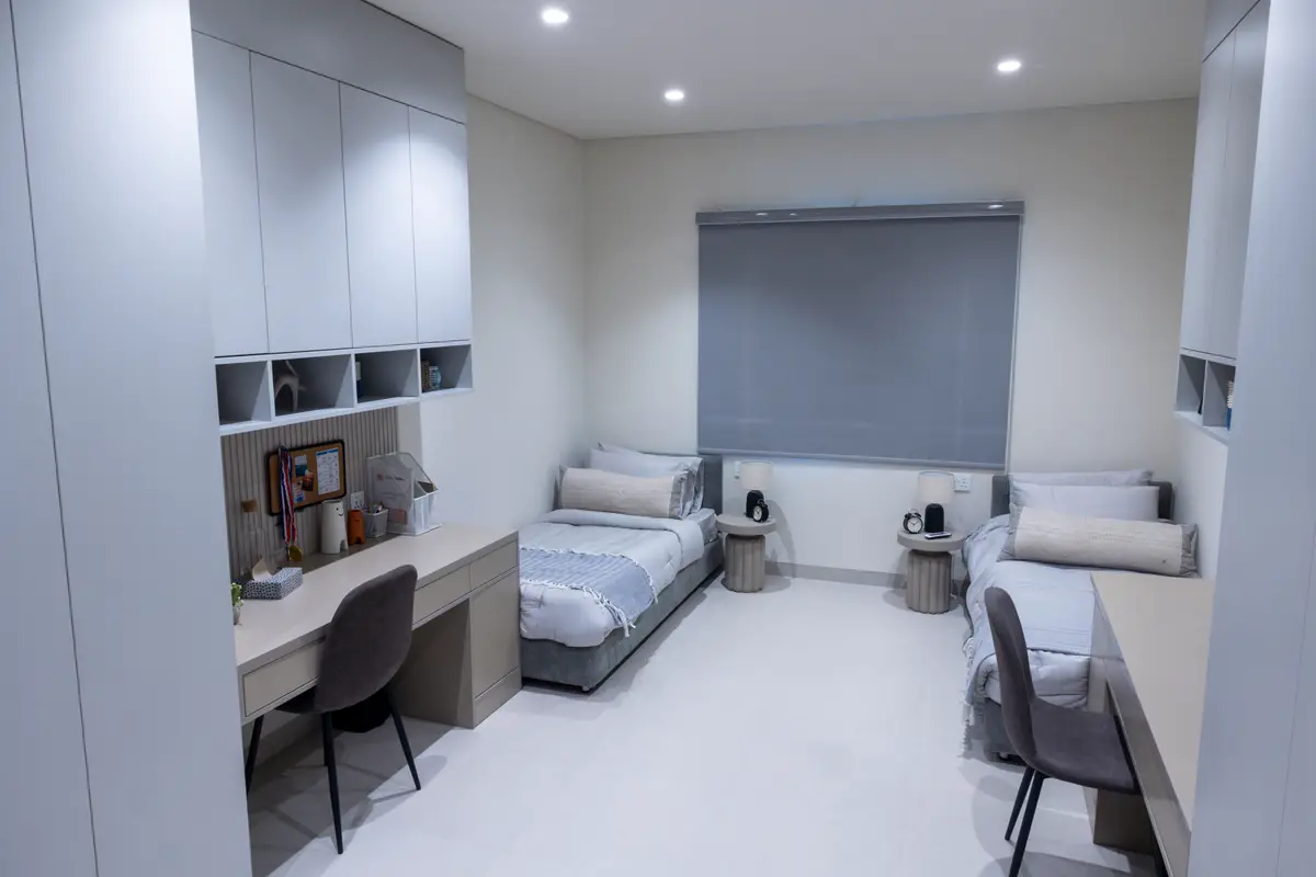 An on-campus student studio at UTB with beds and a study desk.