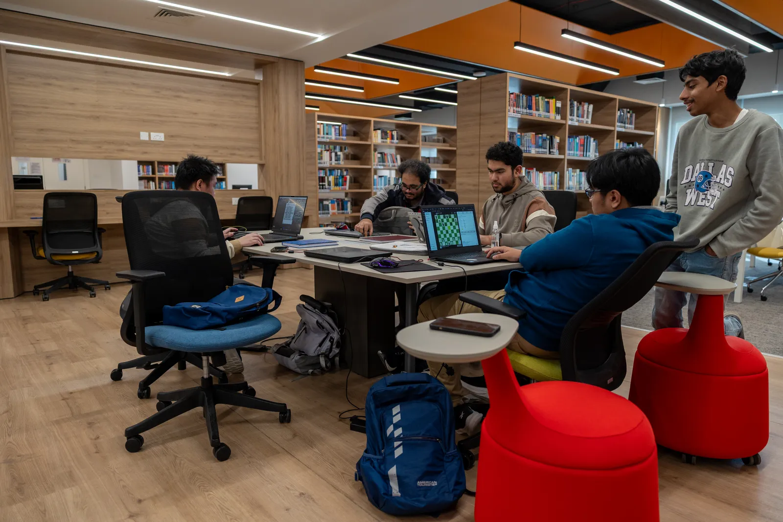 Students studying together at a shared table in the UTB library.